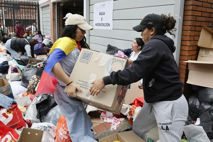 Voluntarias cargando cajas de ayuda en un punto de recogida